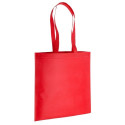 Culotte polaire rouge dans un sac assorti à longue poignée avec étiquette personnalisée et autocollant de Noël